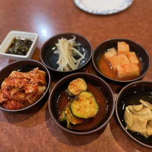 five bowls of food on a table