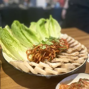 a plate of noodles and lettuce on a table