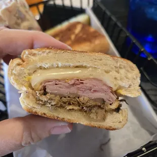 CUBANO: Braised shredded pork, ham, swiss cheese, sliced pickles, French's mustard on a pressed 8" sub roll