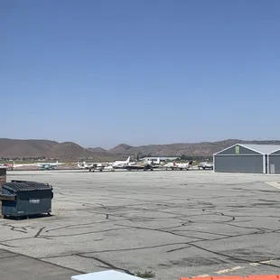 a parking lot with a plane in the background
