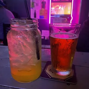 a mason jar with a drink and a beverage