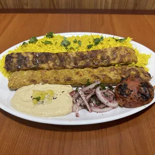 Chicken Kebab plate with our famous yellow rice, half a grilled tomato, grilled onions and a side of hummus