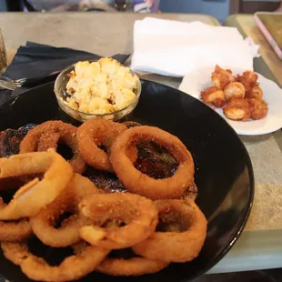 a plate of onion rings and mashed potatoes