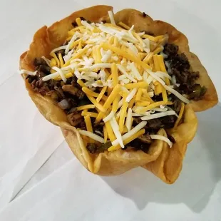 a taco dish with cheese on top