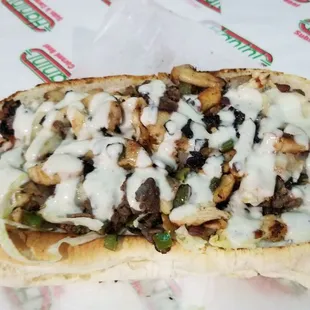 a hot dog covered in cheese and toppings