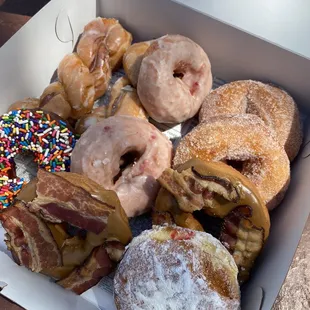 Glazed twist, glazed cherry, sugared cake, maple bacon, chocolate sprinkled and powdered with raspberry filling