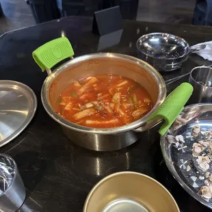 Spicy rice cake appetizer comes in a whole pot