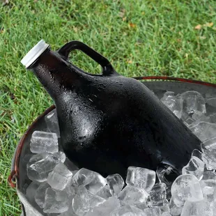 a beer bottle in a bucket filled with ice