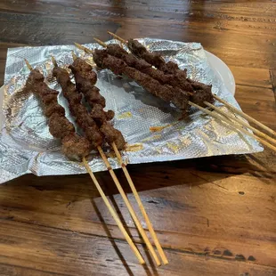 Lamb skewers on the left and beef skewers on the right