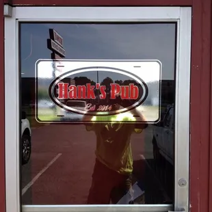 a reflection of a man in the window