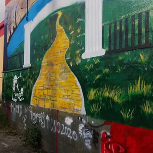 a mural of a yellow brick road