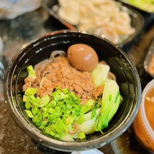 a bowl of soup with meat and vegetables