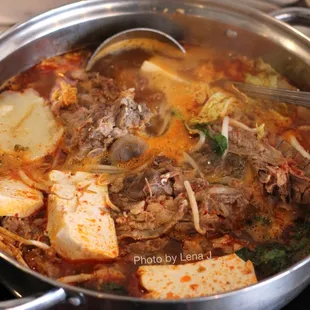 Gamjatang A  ($37.95) - Pork backbone soup w/ potatoes, tofu, napa, watercress, beansprouts