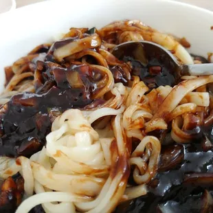 a bowl of food with onions and sauce