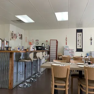 the interior of a restaurant with tables and chairs