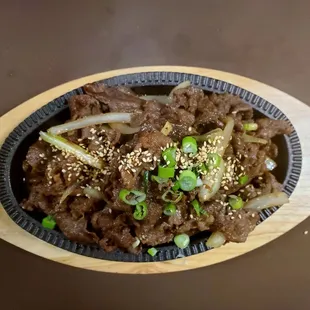 a plate of beef and onions