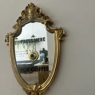 the reflection of a coffee shop sign in a mirror