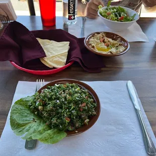 a plate of salad and a can of soda on a table