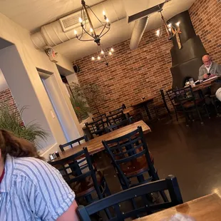 a woman sitting at a table in a restaurant