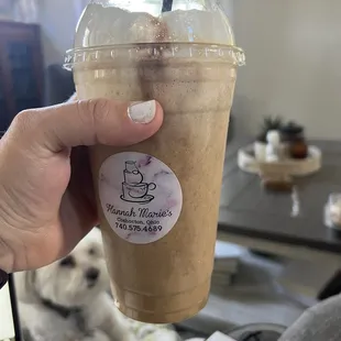 a hand holding a cup of coffee