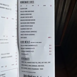 a hand holding a menu
