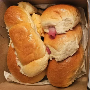 Box of goodies.  Item on left was on special (buy 4, get 1 free) - delicious coconut filling.  Ham &amp; Cheese buns.