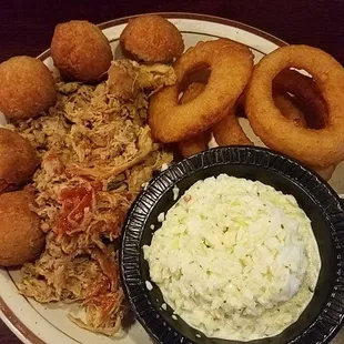 Smoked porked BBQ with hush puppies, onion rings and coleslaw.