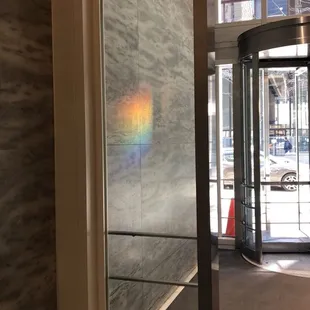 a rainbow reflected in a window