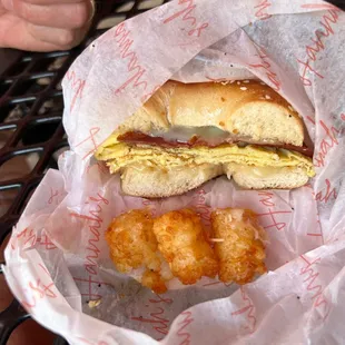 Breakfast sandwich on a bagel with taters