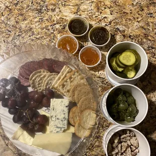 $55 charcuterie to feed 3-5 people. Picked up for takeout.15 crackers,9 slices salami. Crackers soft from fridge.