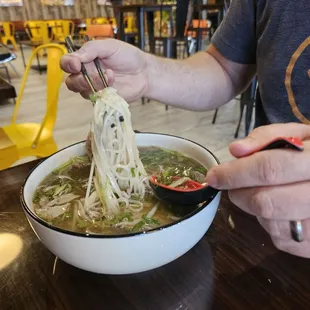 Beef pho  the broth was delicious and the thin sliced beef was still perfectly pink when the bowl was brought to the table.