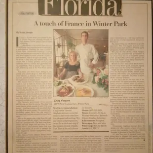 a man and woman in front of a plate of food