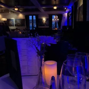 a candle and a vase of flowers