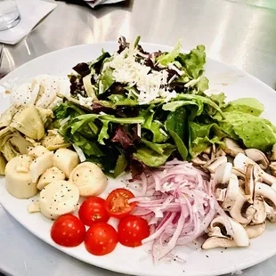 a plate of salad and vegetables