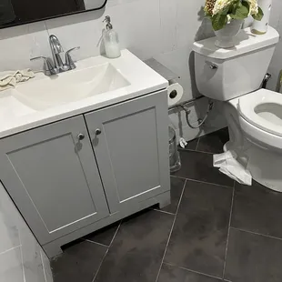 Restroom has a dirty towel on the sink.