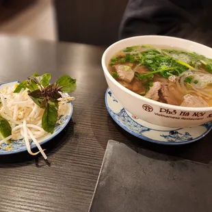 a bowl of soup and a plate of noodles