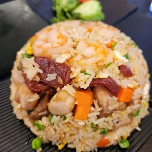 a fried rice dish with shrimp and vegetables