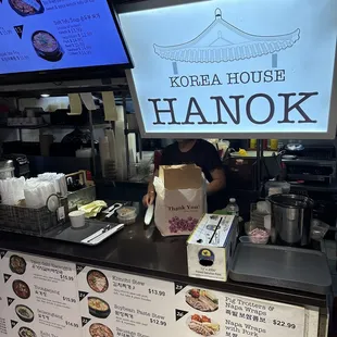 a woman ordering food at a restaurant