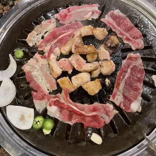 a variety of meats on a grill