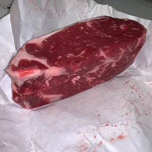 a piece of beef on a piece of paper