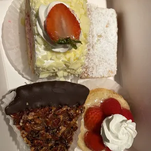 Assorted goodies: choco dipped pecan pie, strawberry shortcake, strawberry mousse cake slice, lemon bar