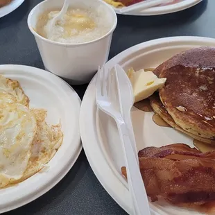 Breakfast platter. Eggs over easy, bacon, cheese grits, pancakes