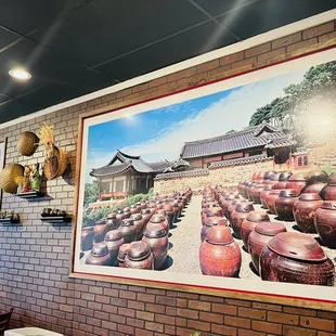 a brick wall with a picture of a building