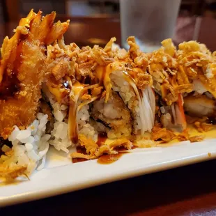 Hansang Gimbap: shrimp tempura, crabmeat, avocado, vinegar, spicy mayo, eel sauce, topped with fried onions