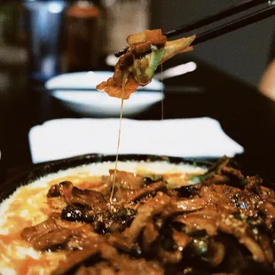 a plate of food with chopsticks