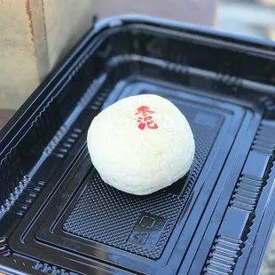 a half eaten doughnut in a plastic container