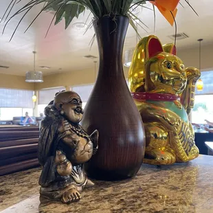 a statue of a monkey and a vase of flowers