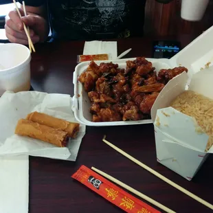 Orange chicken, fried rice, meat egg rolls and egg drop soup