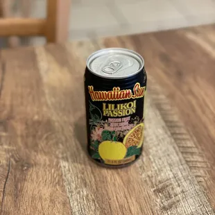 a can of lemonade on a wooden table