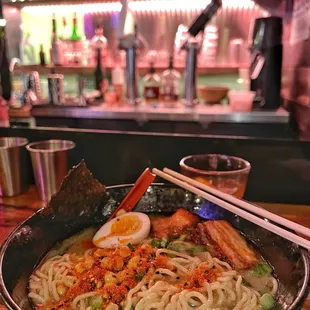 a bowl of ramen and chopsticks